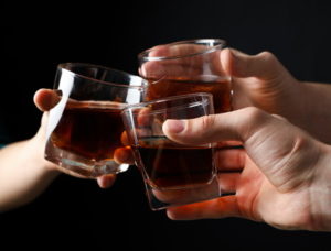 three whisky glasses cheers